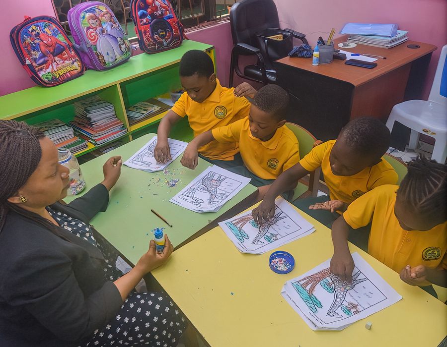 Creche pupils working with a teacher at Golden Gate Schools